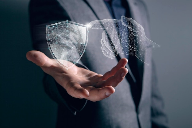 A hand from the net presses the shield Cyber protection Man holding in his hand