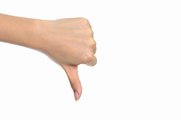 hand giving thumbs down against white wall