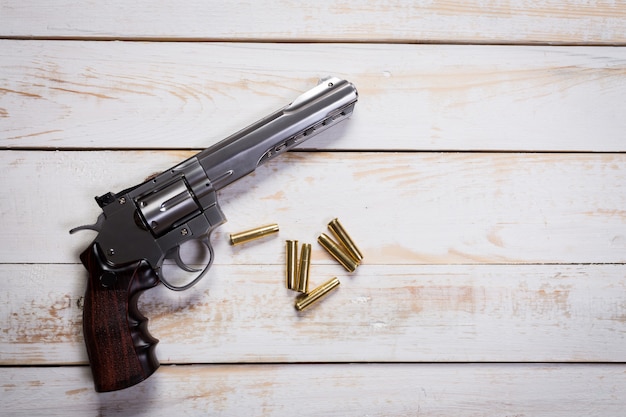 Hand gun with rounds on wooden desk