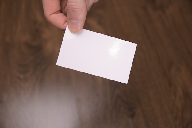 Hand hold blank white card mockup with rounded corners. Plain call-card mock up template holding arm. Plastic credit namecard display front. Check offset card design. Business branding.