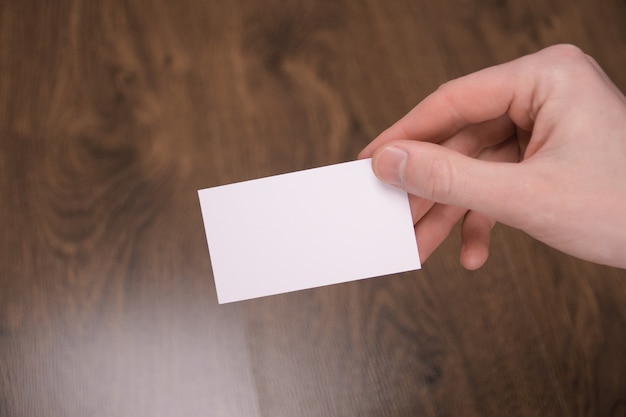 Hand hold blank white card mockup with rounded corners. Plain call-card mock up template holding arm. Plastic credit namecard display front. Check offset card design. Business branding.