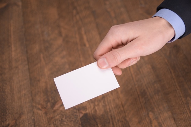 Hand hold blank white card mockup