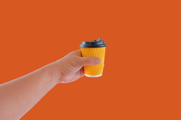 Hand hold a hot drink in to go paper cup