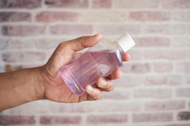 Hand hold a mouthwash liquid container