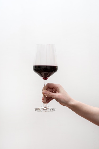 Hand hold red wine glass 