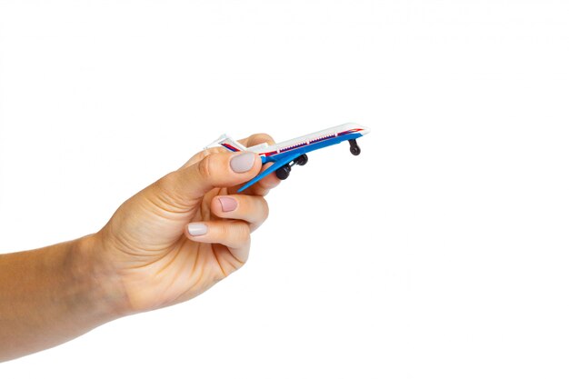 Hand holding airplane toy model isolated