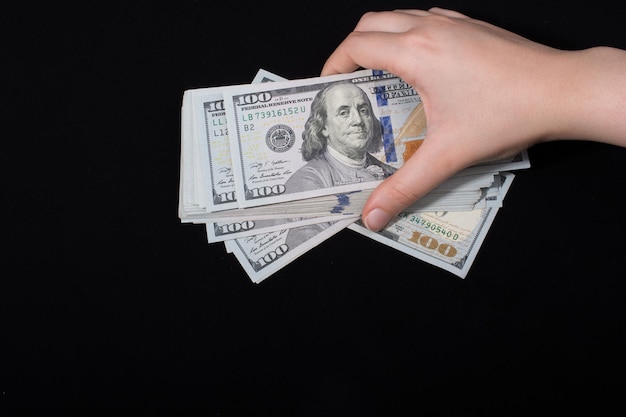 Hand holding American dollar isolated on white background