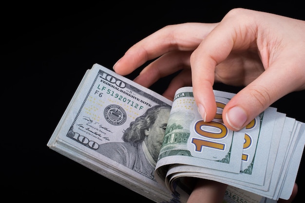 Hand holding American dollar isolated on white background