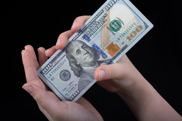 Hand holding American dollar isolated on white background