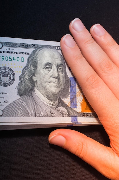 Hand holding American dollar isolated on white background