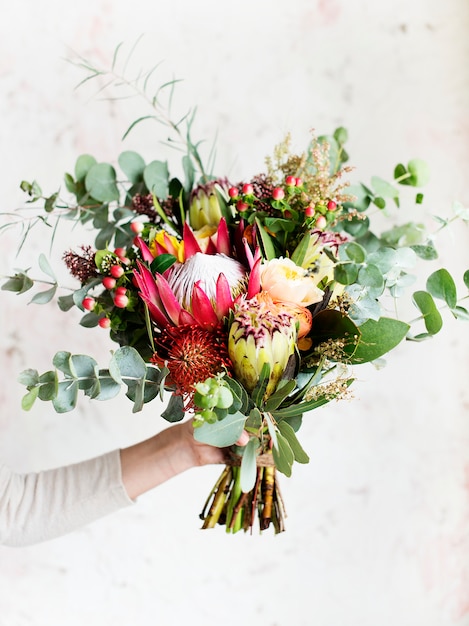 Hand holding beautiful bouquet of flowers