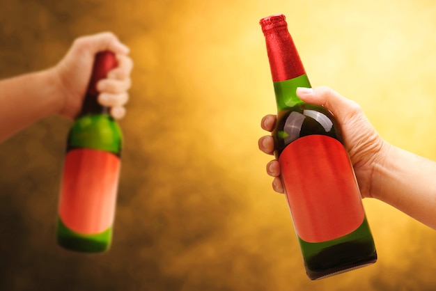 Hand holding beer bottle closeup