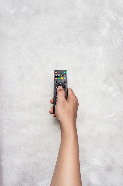 hand holding black remote