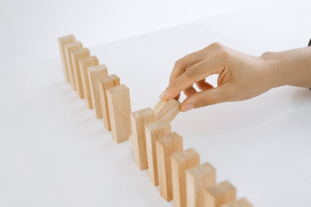 Hand holding block wood game Concept Risk of management and strategy plan growth business teamwork