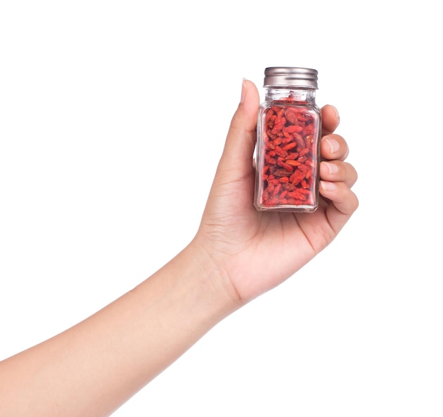 hand holding bottle of Goji Wolfberries isolated on white background