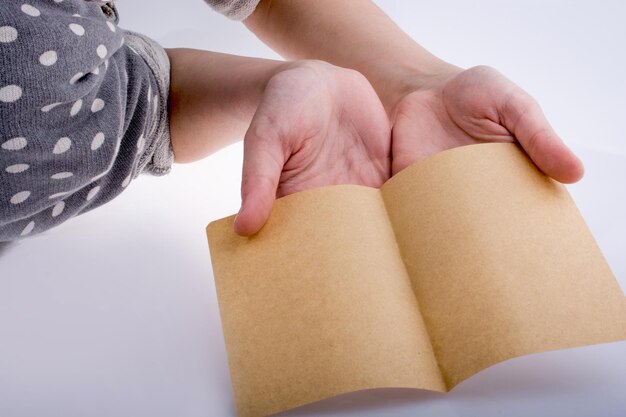 Hand holding a brown color paper