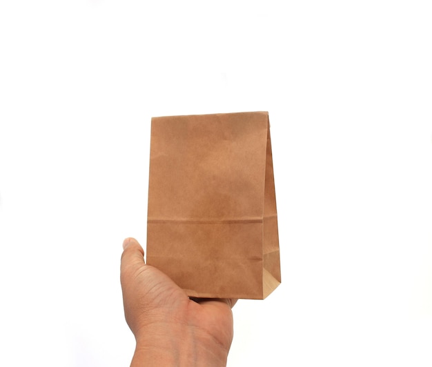 Hand holding a brown paper bag