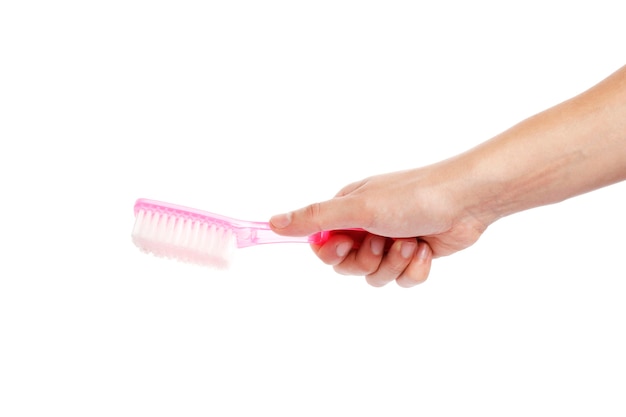 Hand holding a brush isolated on white background