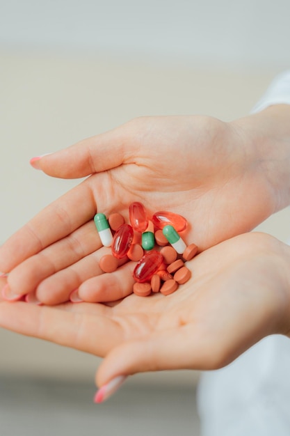 A hand holding a bunch of pills