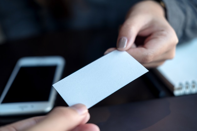 Hand holding a business card