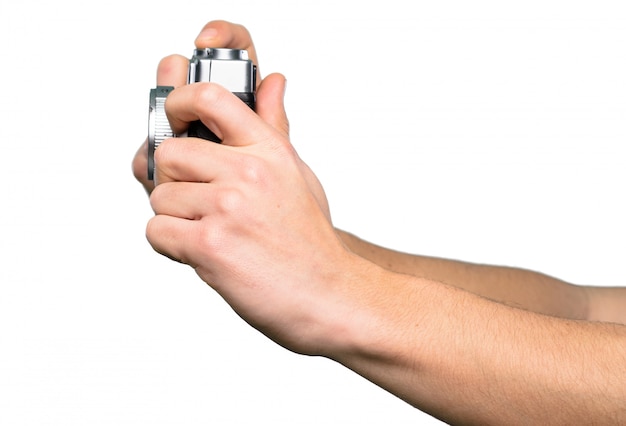 Hand holding Camera over isolated white background