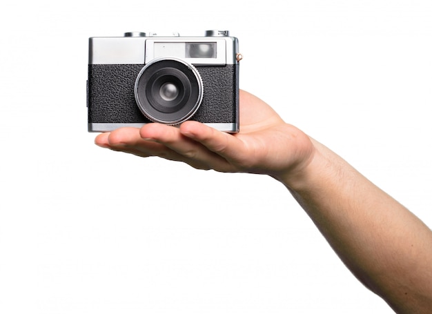 Hand holding Camera over isolated white background