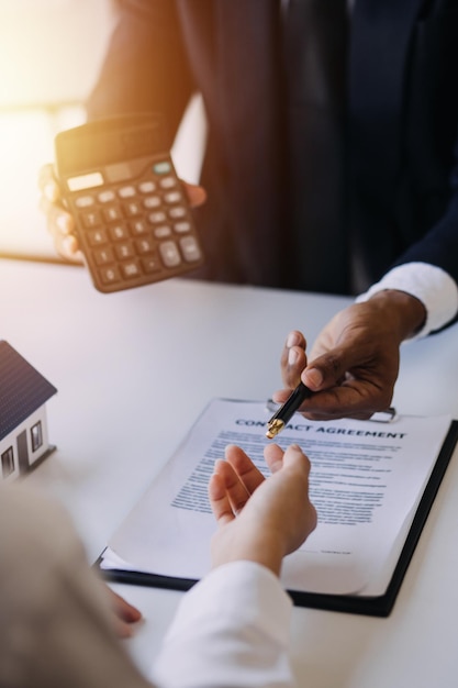 Hand holding car keys and car rental concept A closeup view of the agent giving the customer the car keys after signing the lease rental form and car name