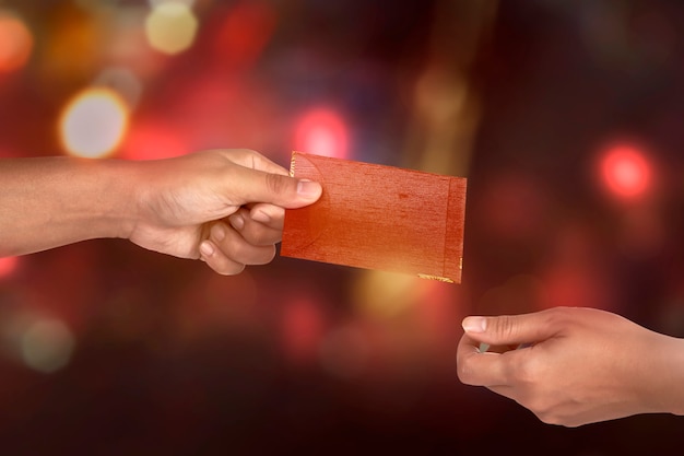 Hand holding chinese red envelope