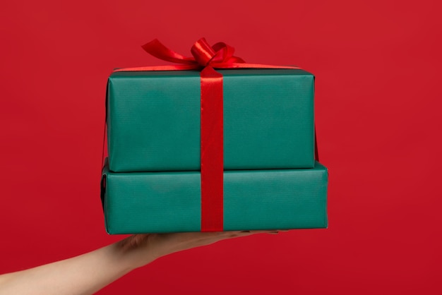 Hand holding Christmas present isolated