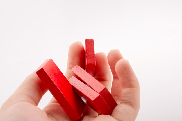 Hand holding color domino pieces in hand