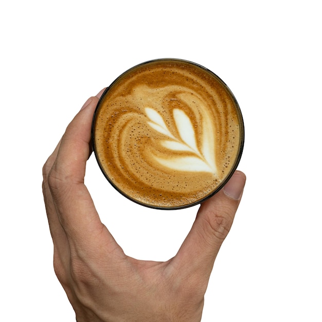 A hand holding a cup of coffee with a latte art on it.