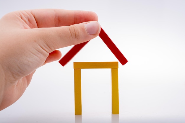 Hand holding domino forming a house