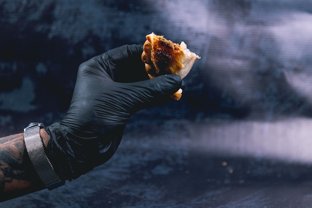 hand holding an empanada from argentina