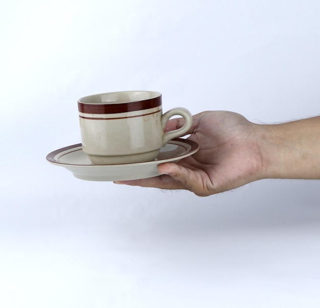 hand holding a glass of cup on a white background