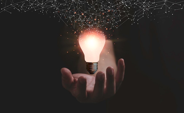 Hand holding glowing lightbulb with connection line for creative thinking idea and innovation concept