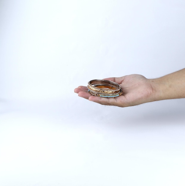 hand holding gold bracelet jewelry on white background