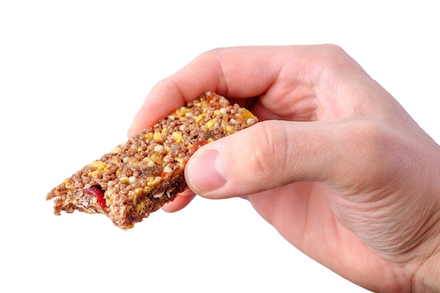 Hand holding granola bar isolated on white background