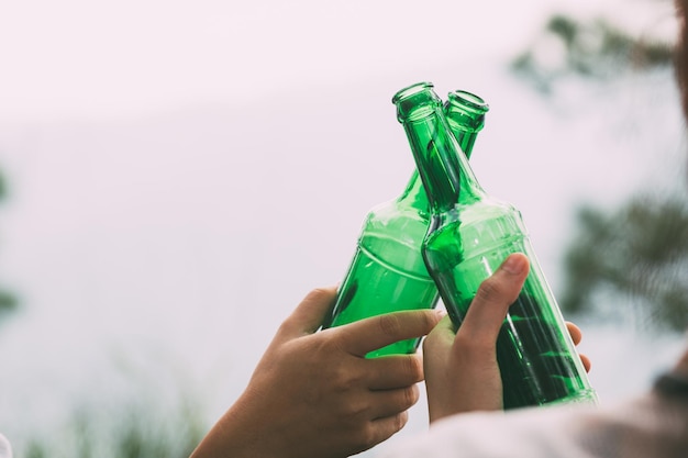 Hand holding a green drink bottle