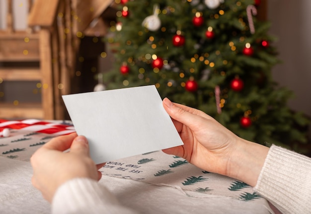 Hand holding greeting card mockup Blank paper for business background female with postcard