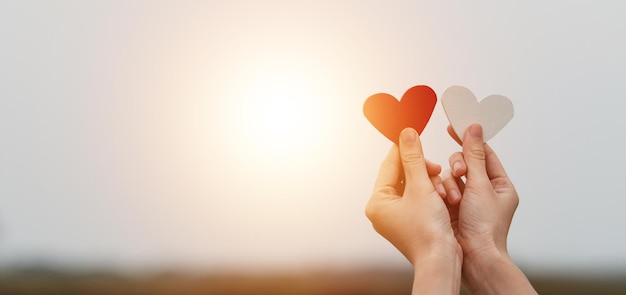 Hand holding heart on sky sunset , Love in Valentine's day, Happy Valentine, World heart day