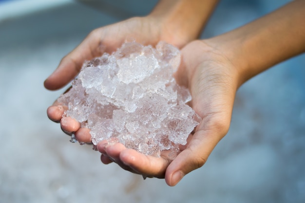 Hand holding ice cubes