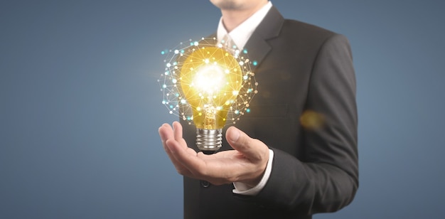 Hand of holding illuminated light bulb, idea, innovation inspiration concept