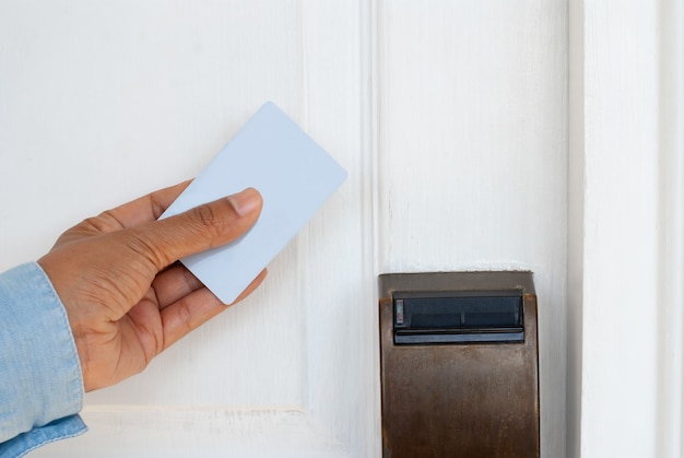 Hand Holding Key Card for Unlocking Door