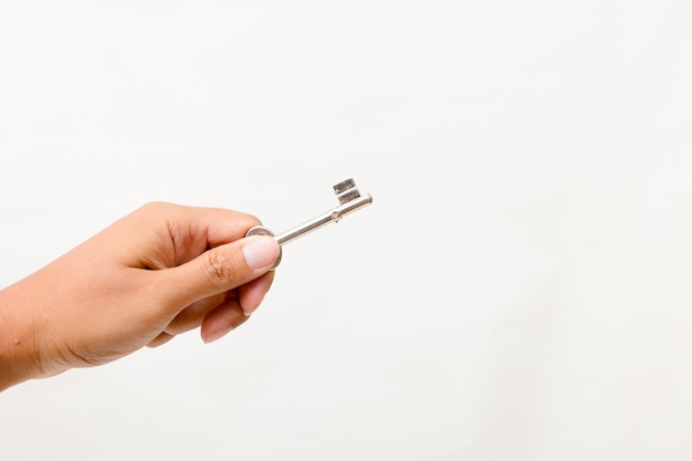 Hand holding the key Isolated. Studio lighting. 