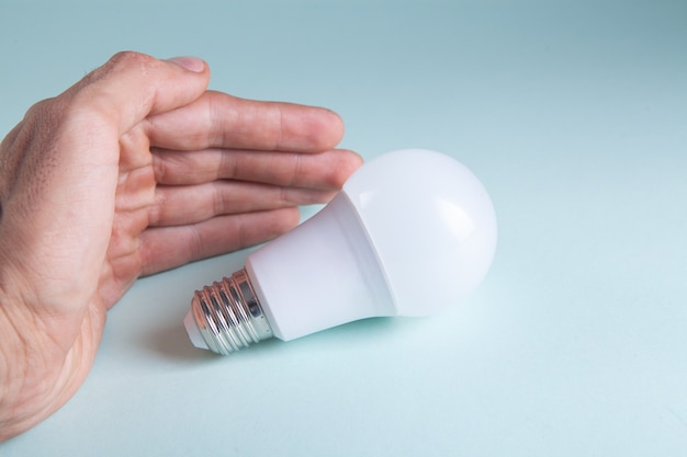 Hand holding a light bulb