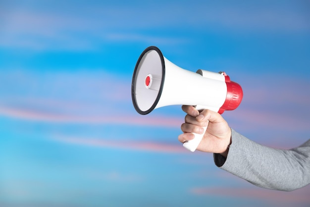 Hand holding a loudspeaker