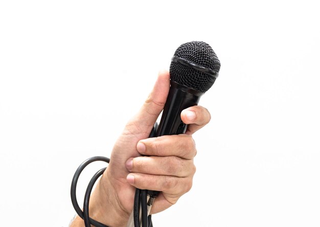 Hand holding a microphone isolated on white background