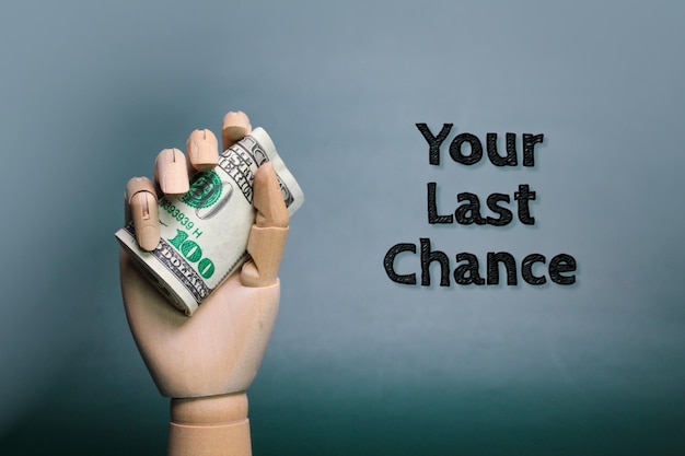 hand holding money with the words your last chance