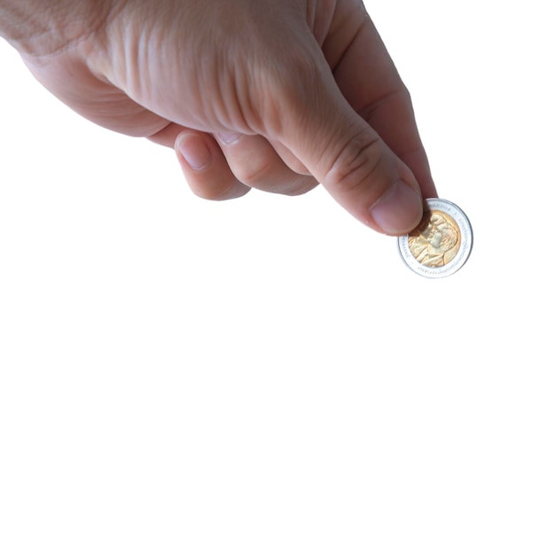 Hand holding old coin isolated over white background