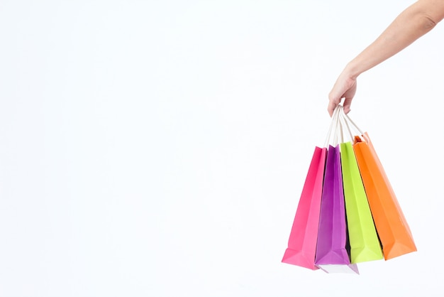 hand holding paper shopping bags isolated on white background